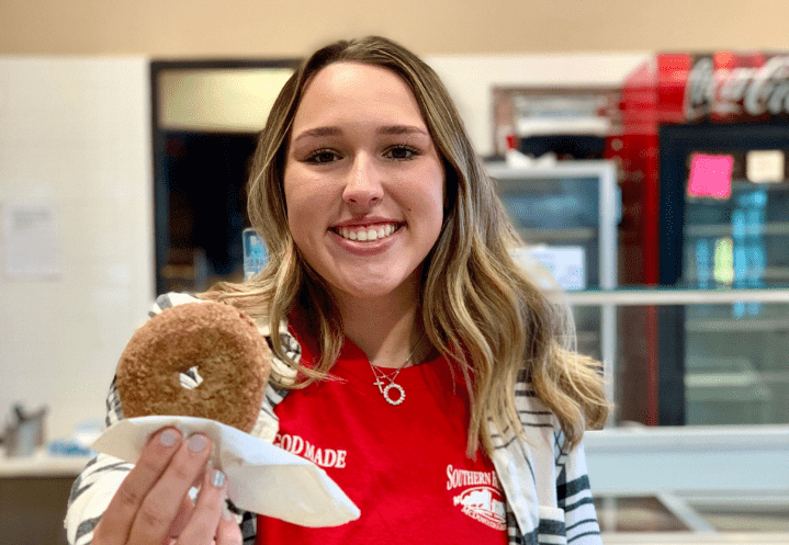 Person Holding Southern Belle Farm Apple Cider Donut