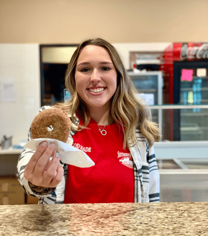 Person Holding Southern Belle Farm Apple Cider Donut