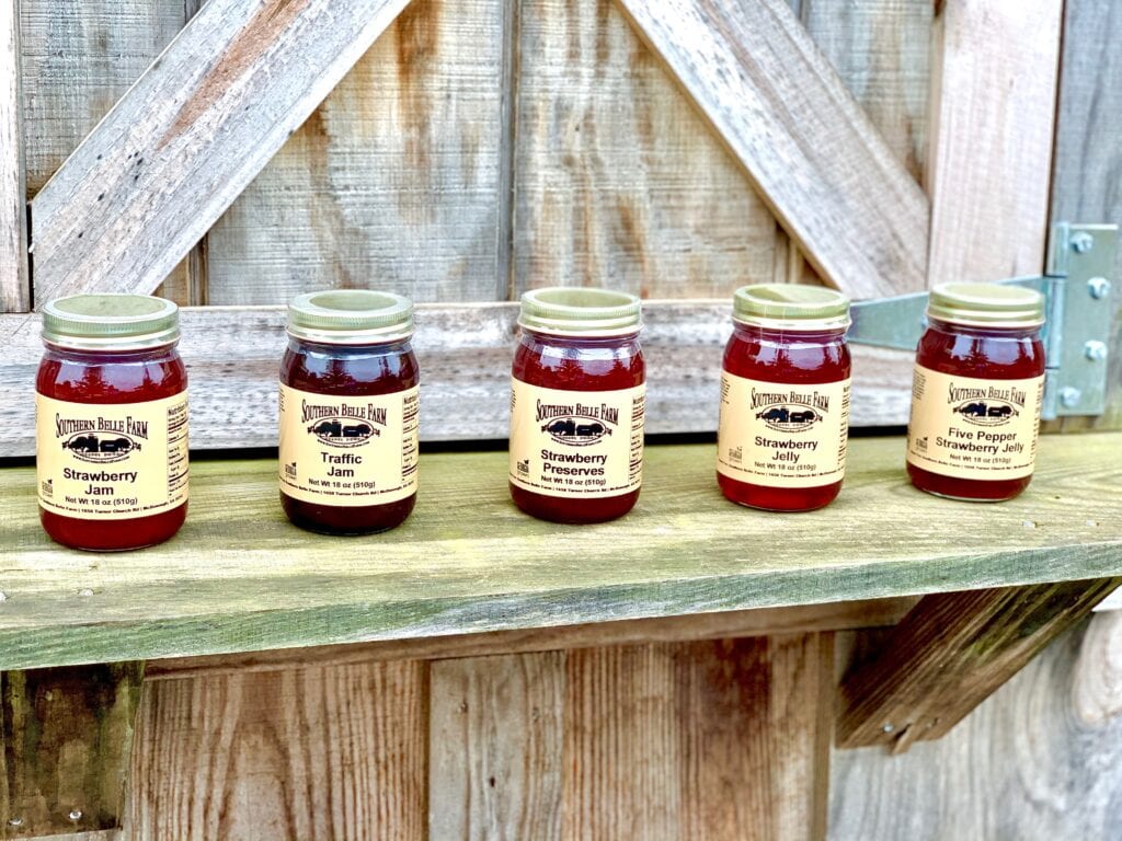 a row of jam jars on a wooden ledge
