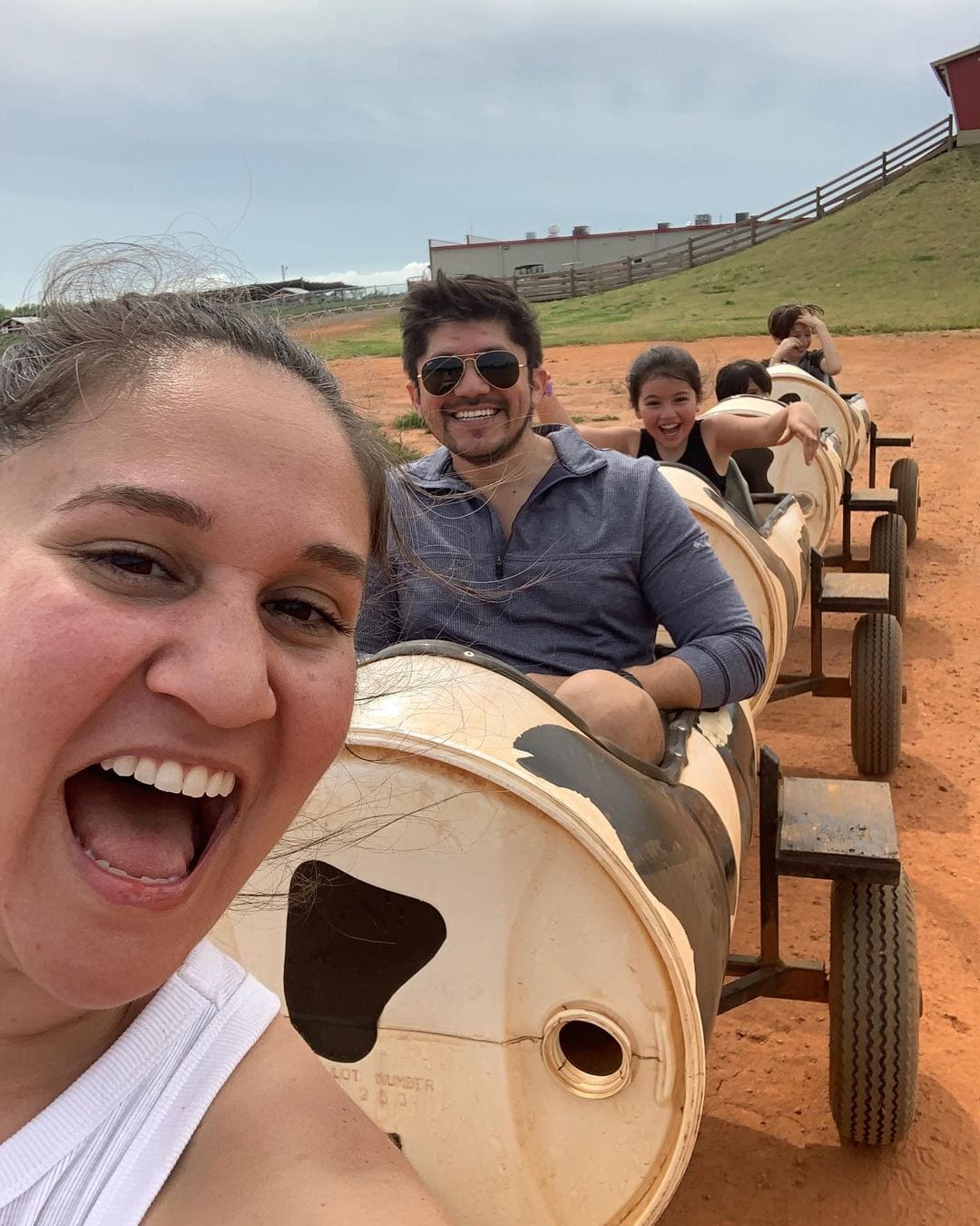 A family laughing on a cow train