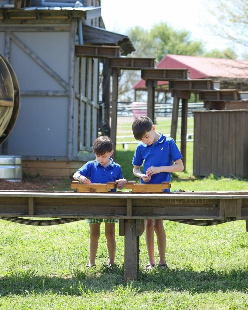 two boys playing at a gem mining activity