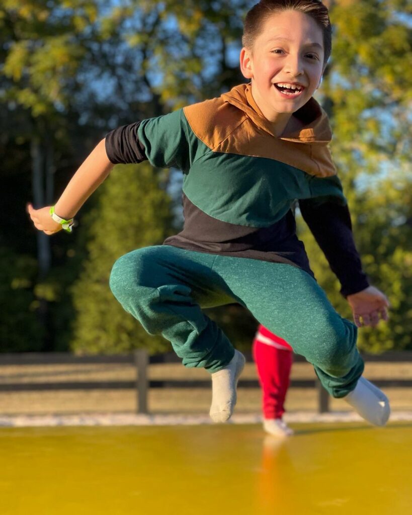 Boy smiling on jumping pillow